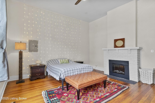 612 E Ormsby Ave, Louisville, KY 40203 - bedroom featuring wood finished floors, a brick fireplace, and a ceiling fan