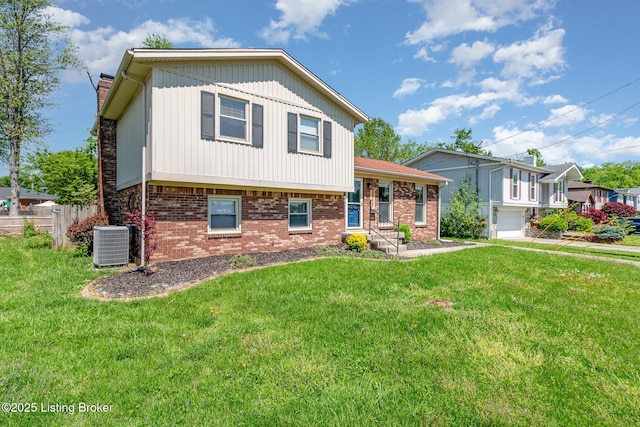 split level home featuring central AC, fence, a chimney, and a front yard