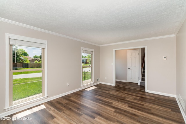 spare room featuring ornamental molding, dark wood-style flooring, stairs, baseboards, and a textured ceiling