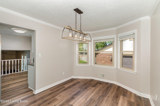 unfurnished dining area featuring a notable chandelier, a textured ceiling, baseboards, dark wood-type flooring, and visible vents