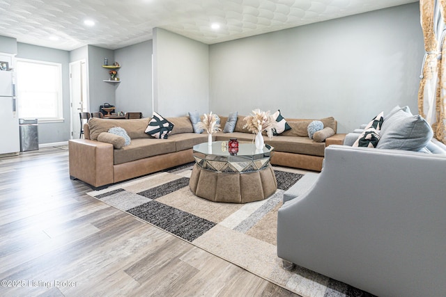 living room with recessed lighting and wood finished floors