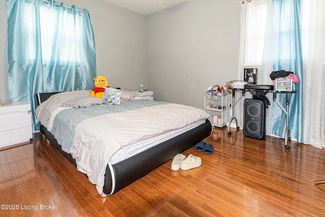 bedroom with wood-type flooring