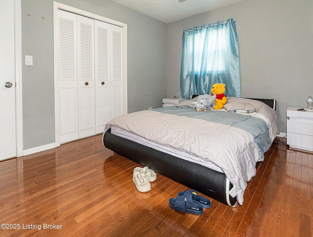 bedroom with a closet and hardwood / wood-style floors