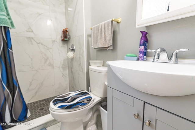 bathroom with vanity, a stall shower, and toilet