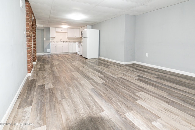 unfurnished living room featuring light wood-style floors, baseboards, and visible vents
