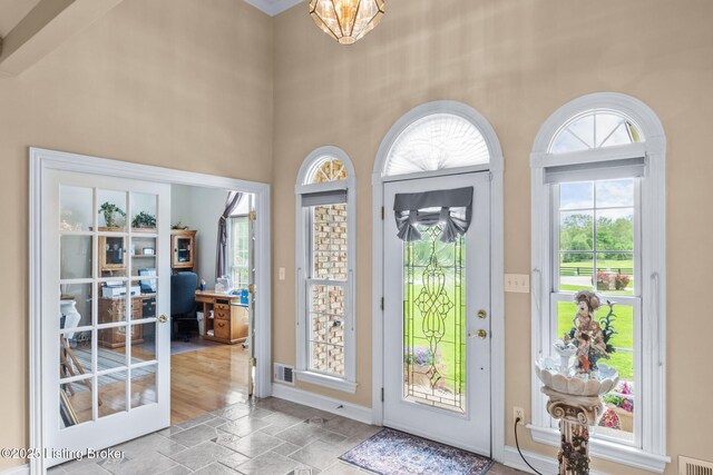 15815 Crystal Valley Way, Louisville, KY 40299 - doorway featuring stone tile floors, a desk, plenty of natural light, a high ceiling, and baseboards