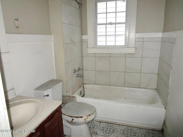 bathroom with vanity, tub / shower combination, and toilet