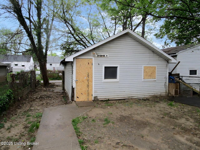 back of house with fence