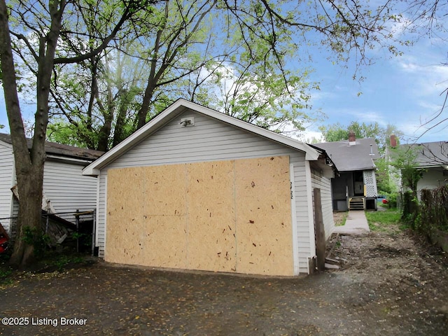 view of side of property with entry steps and a garage