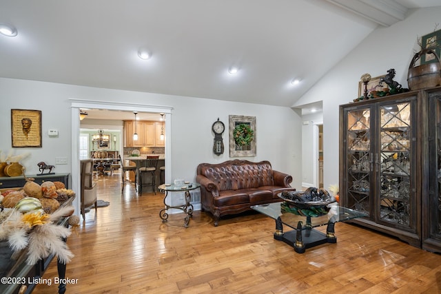 living room featuring recessed lighting, lofted ceiling with beams, and light wood finished floors