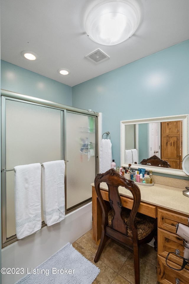 full bath with vanity, combined bath / shower with glass door, and visible vents