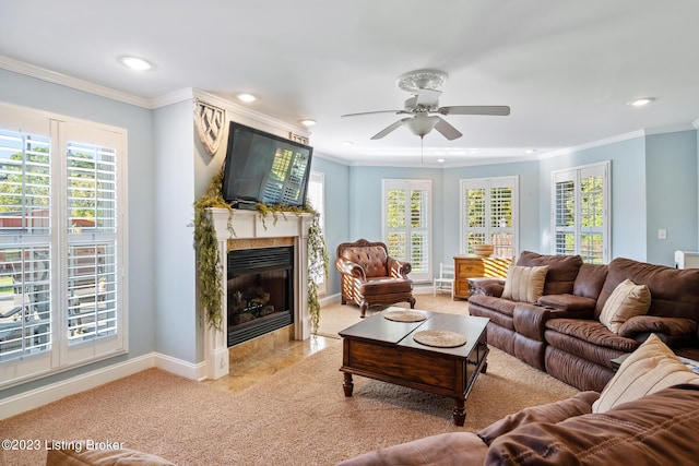 living area with recessed lighting, a ceiling fan, ornamental molding, and a tile fireplace