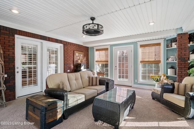living area featuring wooden ceiling, carpet, and brick wall