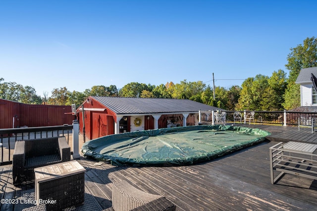 view of swimming pool featuring a deck