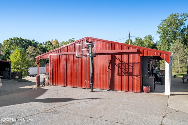 view of gate with an outdoor structure and a pole building