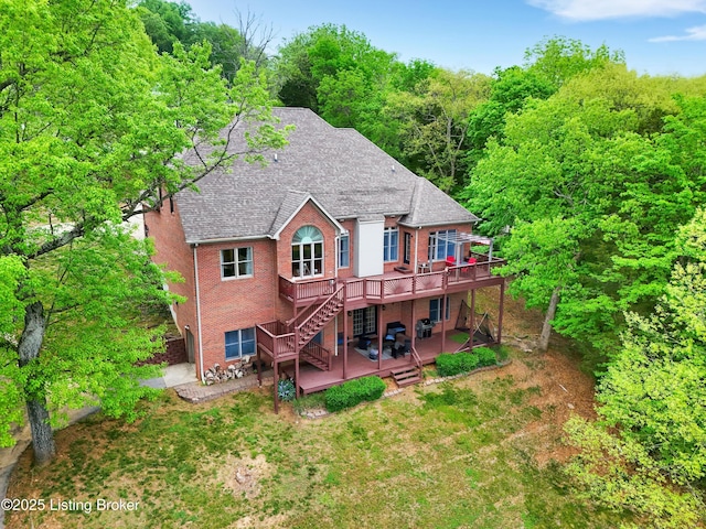 302 Hampton Rd, Brandenburg, KY 40108 - back of property featuring roof with shingles, stairs, brick siding, a deck, and a patio area