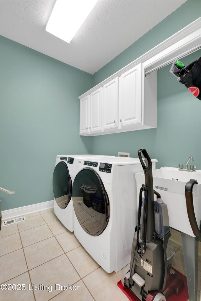 302 Hampton Rd, Brandenburg, KY 40108 - clothes washing area with cabinet space, visible vents, light tile patterned floors, and washing machine and clothes dryer