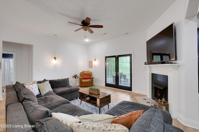 302 Hampton Rd, Brandenburg, KY 40108 - living area featuring light wood-style floors, baseboards, a ceiling fan, and a fireplace with flush hearth