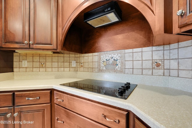 302 Hampton Rd, Brandenburg, KY 40108 - kitchen with light countertops, brown cabinets, black electric stovetop, and tasteful backsplash