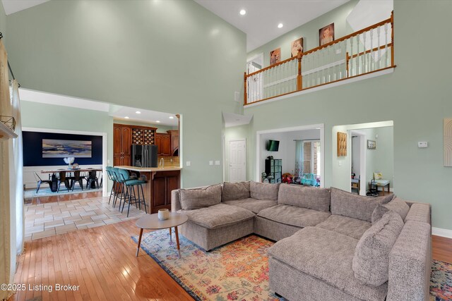 302 Hampton Rd, Brandenburg, KY 40108 - living room featuring light wood-type flooring, recessed lighting, baseboards, and a towering ceiling