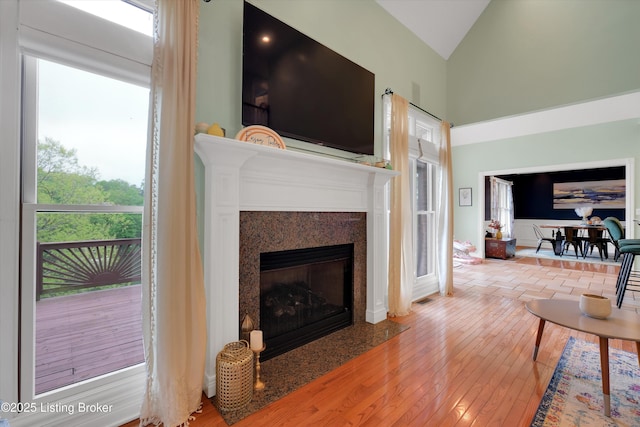 302 Hampton Rd, Brandenburg, KY 40108 - living area with high vaulted ceiling, visible vents, hardwood / wood-style flooring, and a fireplace