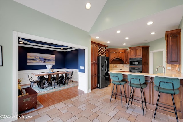 302 Hampton Rd, Brandenburg, KY 40108 - kitchen featuring light countertops, a peninsula, recessed lighting, a kitchen bar, and black appliances