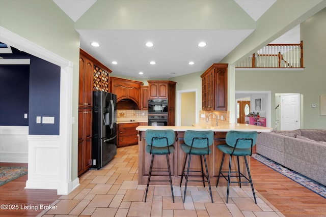 302 Hampton Rd, Brandenburg, KY 40108 - kitchen with light countertops, black appliances, a peninsula, open floor plan, and a breakfast bar
