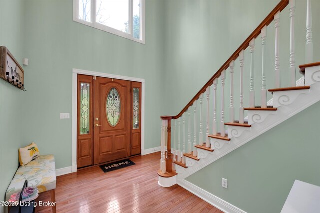 302 Hampton Rd, Brandenburg, KY 40108 - entrance foyer with baseboards, a high ceiling, hardwood / wood-style flooring, and stairway