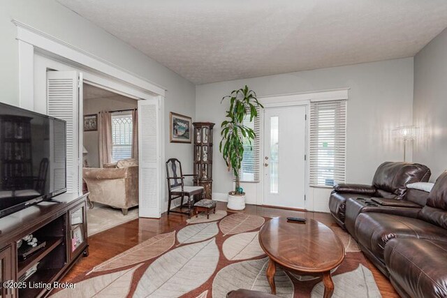 656 S 39th St, Louisville, KY 40211 - living area with baseboards, a textured ceiling, and wood finished floors