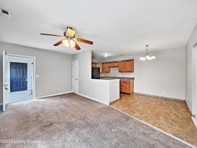 3600 Hillcross Dr, Louisville, KY 40229 - unfurnished living room featuring a chandelier, ceiling fan, baseboards, and light colored carpet