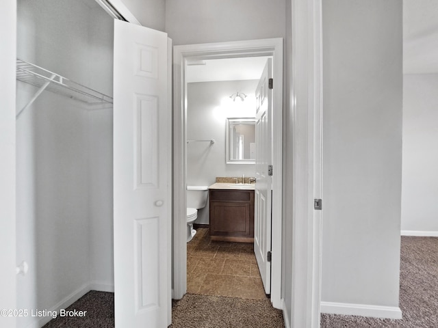 3600 Hillcross Dr, Louisville, KY 40229 - hall featuring dark carpet, baseboards, and a sink