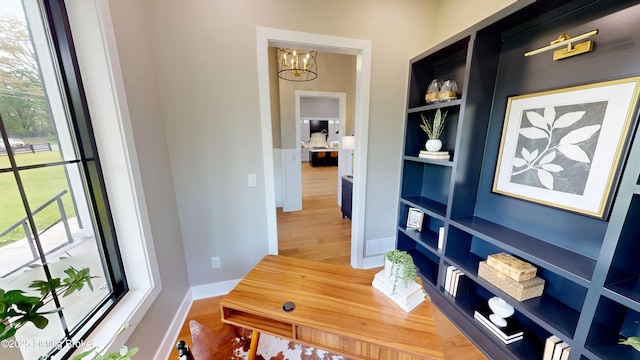 2045 W Rhudes Creek Rd, Elizabethtown, KY 42701 - hallway with an inviting chandelier, built in features, and wood finished floors