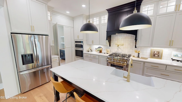 2045 W Rhudes Creek Rd, Elizabethtown, KY 42701 - kitchen with decorative backsplash, pendant lighting, light stone counters, glass insert cabinets, and stainless steel appliances