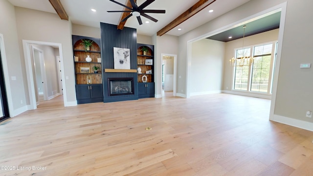 2045 W Rhudes Creek Rd, Elizabethtown, KY 42701 - unfurnished living room featuring beam ceiling, light wood finished floors, a fireplace, ceiling fan with notable chandelier, and baseboards
