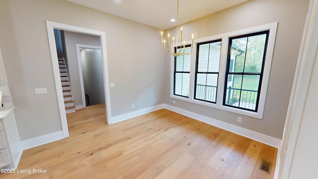 2045 W Rhudes Creek Rd, Elizabethtown, KY 42701 - unfurnished dining area featuring baseboards, visible vents, light wood-type flooring, and a notable chandelier