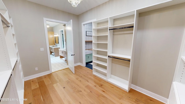 2045 W Rhudes Creek Rd, Elizabethtown, KY 42701 - spacious closet featuring light wood-type flooring and an inviting chandelier