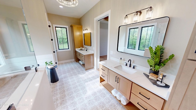 2045 W Rhudes Creek Rd, Elizabethtown, KY 42701 - bathroom with baseboards, a chandelier, two vanities, and a sink