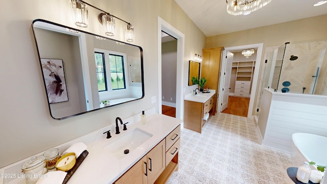 2045 W Rhudes Creek Rd, Elizabethtown, KY 42701 - full bathroom with two vanities, a spacious closet, a shower stall, a sink, and a notable chandelier
