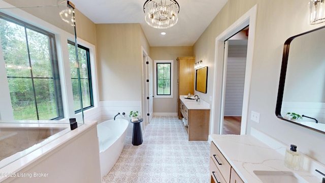 2045 W Rhudes Creek Rd, Elizabethtown, KY 42701 - bathroom with a sink, a freestanding bath, and a healthy amount of sunlight