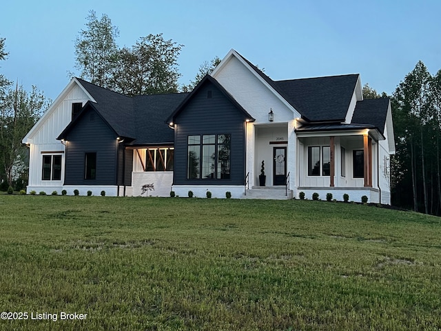 2045 W Rhudes Creek Rd, Elizabethtown, KY 42701 - modern farmhouse style home with board and batten siding, covered porch, roof with shingles, and a front lawn