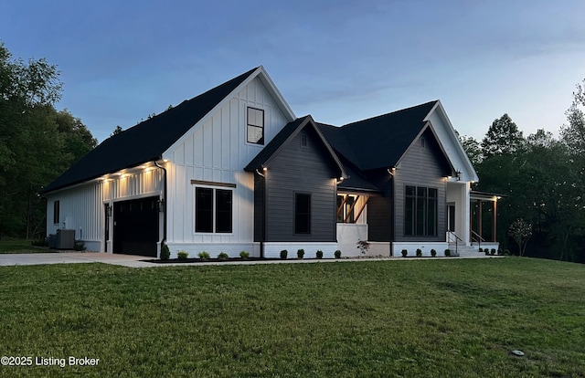 2045 W Rhudes Creek Rd, Elizabethtown, KY 42701 - modern inspired farmhouse with board and batten siding, driveway, central AC unit, and a front lawn