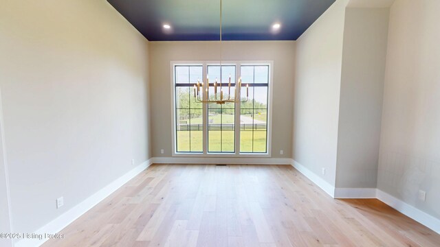 2045 W Rhudes Creek Rd, Elizabethtown, KY 42701 - empty room featuring light wood-style floors, baseboards, recessed lighting, and a chandelier