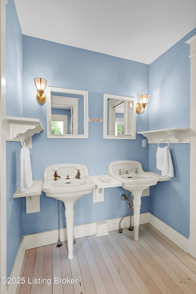 bathroom featuring baseboards and hardwood / wood-style flooring