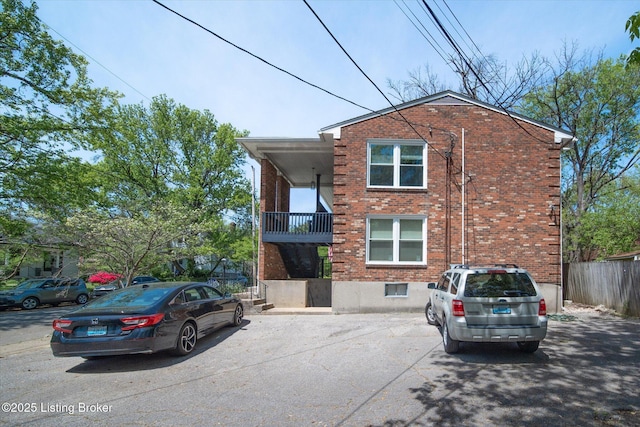 2100 Murray Ave, Louisville, KY 40205 - view of front of home with brick siding, a balcony, and fence
