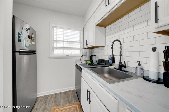 2100 Murray Ave, Louisville, KY 40205 - kitchen featuring stainless steel appliances, a sink, tasteful backsplash, and white cabinets
