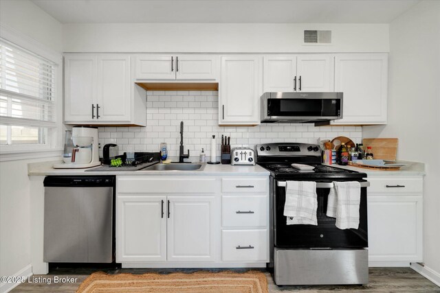 2100 Murray Ave, Louisville, KY 40205 - kitchen featuring stainless steel appliances, a sink, light countertops, and backsplash