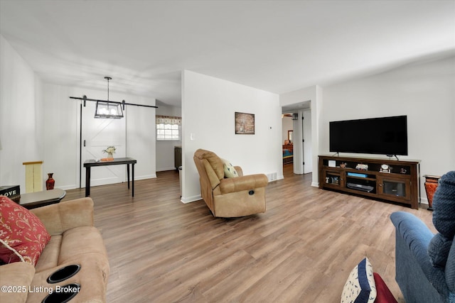 2100 Murray Ave, Louisville, KY 40205 - living room with light wood-style flooring, baseboards, and a barn door