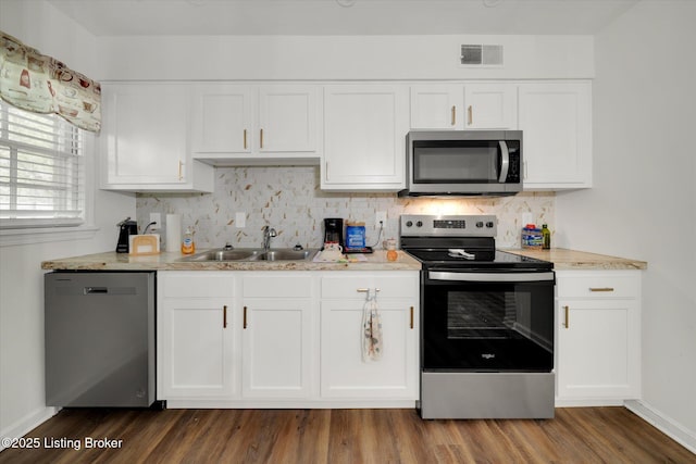 2100 Murray Ave, Louisville, KY 40205 - kitchen featuring appliances with stainless steel finishes, baseboards, backsplash, and white cabinetry