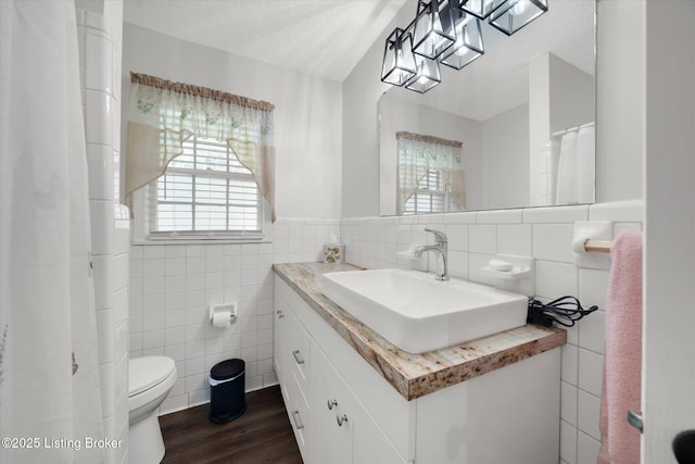 2100 Murray Ave, Louisville, KY 40205 - bathroom with tile walls, wood finished floors, toilet, a textured ceiling, and vanity