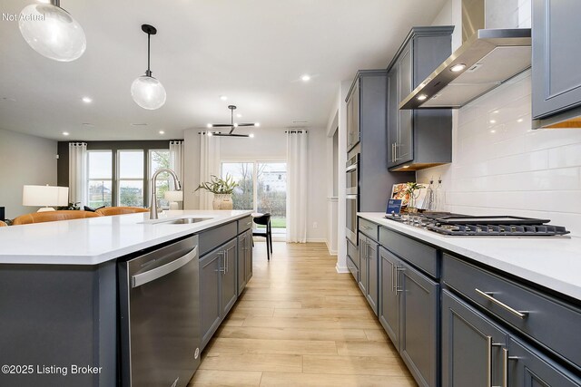 2309 Serenity Rdg Way, Louisville, KY 40023 - kitchen featuring wall chimney range hood, light countertops, a sink, appliances with stainless steel finishes, and gray cabinetry